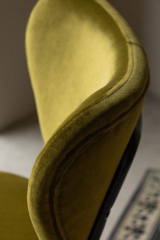 Detail shot of the side of one of the Set Of 2 Dining Chairs In Needlecord Velvet Green.