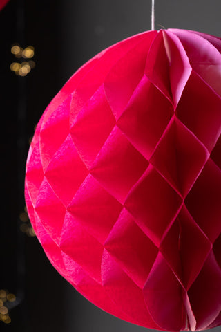 Close-up of one of the Set Of 2 Hot Pink Honeycomb Balls.