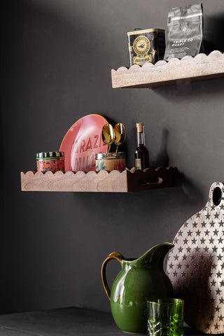 The Set Of 2 Natural Wooden Scalloped Wall Shelves styled on a dark wall with various kitchen accessories on.