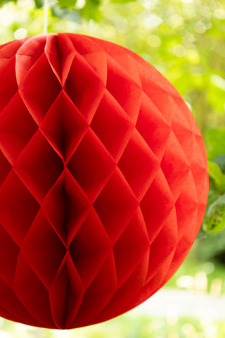 Set Of 2 Red Honeycomb Ball Decorations hanging from tree detail