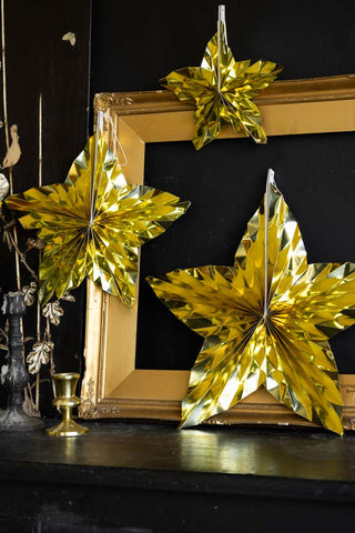 Set Of 3 Metallic Gold Paper Stars hanging on frame