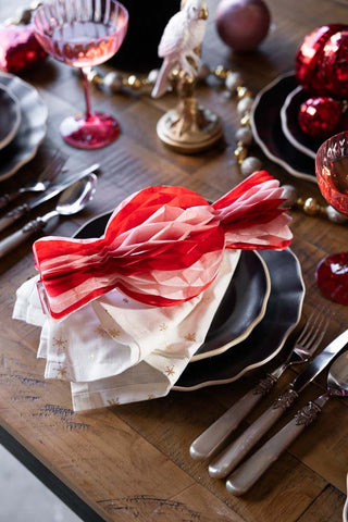 One of the Set Of 3 Pink & Red Honeycomb Sweets styled on a Christmas place setting on a table.