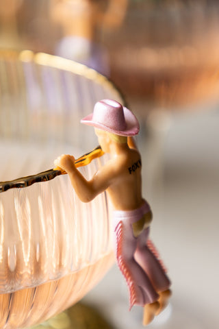 Pink dressed cowboy drink marker with 'foxy' tattooed on the back.