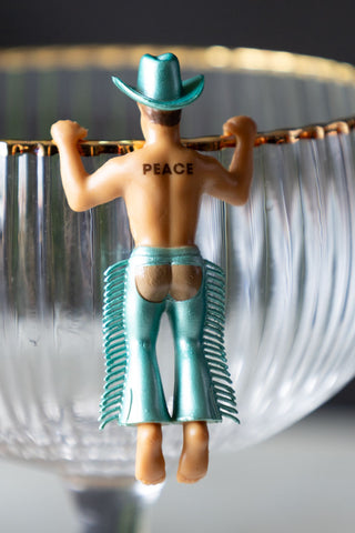 A cowboy drink accessory dressed in blue with 'peace' tattooed on the back.