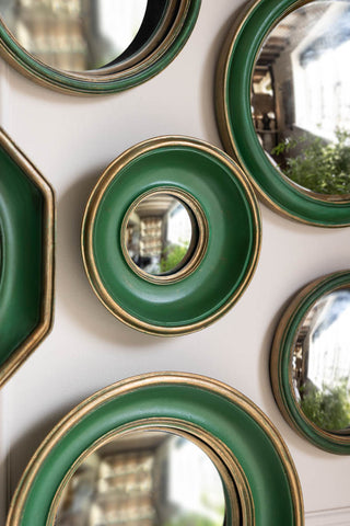 Close-up of some of the Set of 12 Antique Green & Gold Convex Framed Mirrors displayed on the wall.