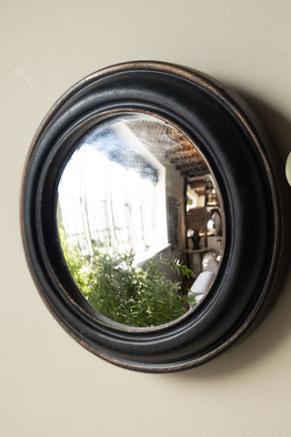 Close-up of one of the Set of 12 Black Convex Framed Mirrors on a neutral wall.