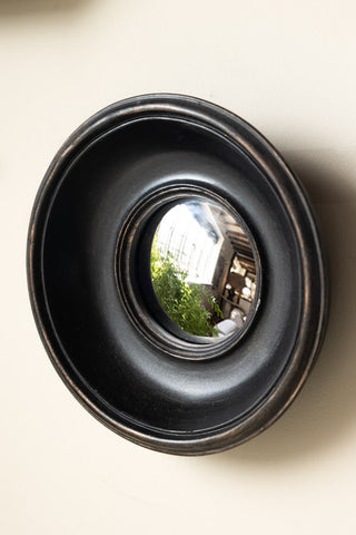 One of the Set of 12 Black Convex Framed Mirrors on a neutral wall.