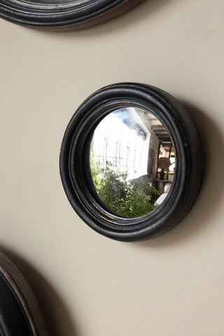 Some of the Set of 12 Black Convex Framed Mirrors styled on a neutral wall.