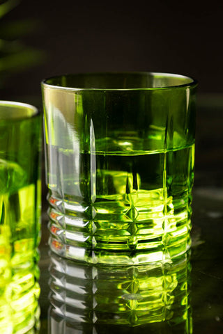 Detail shot of one of the Set of 2 Green Whiskey Embossed Glasses.