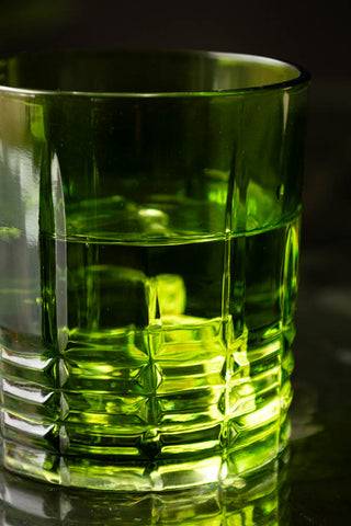 Close-up of one of the Set of 2 Green Whiskey Embossed Glasses.