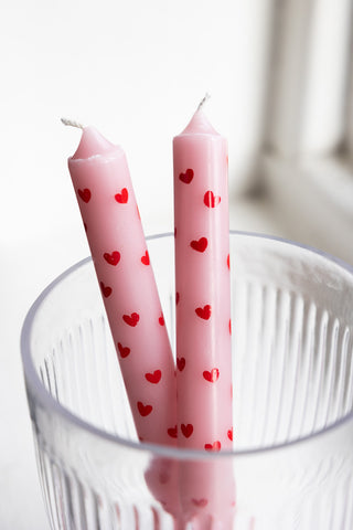 The Set of 2 Red & Pink Heart Dinner Candles displayed in a glass container.