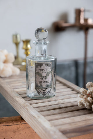 One of the Set of 3 Apothecary-Style Poison Decanter Bottles styled on a bath tray.