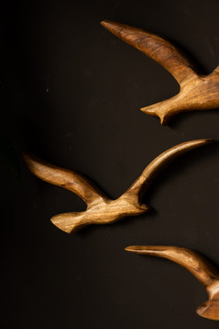 Detail shot of the Set of 3 Birds Wall Ornament on a black wall.