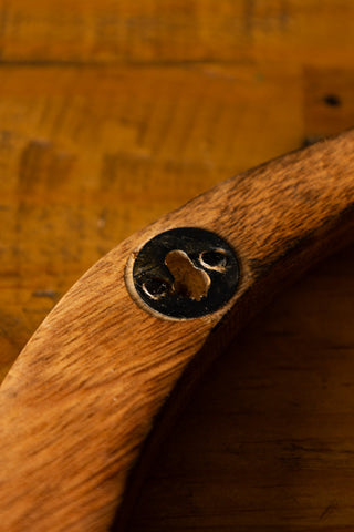 Detail shot of the fixture on the reverse side of one of the Set of 3 Birds Wall Ornament, displayed on a wooden surface.