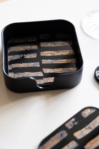 Close-up of the holder of the Set of 4 Black & Gold Brushstroke Coasters With Holder.