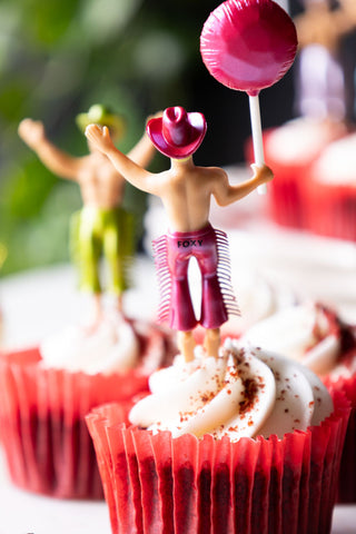 Close-up of the reverse side of one of the Set of 4 Cowboy Cake Toppers, displayed in a cupcake in a red case.