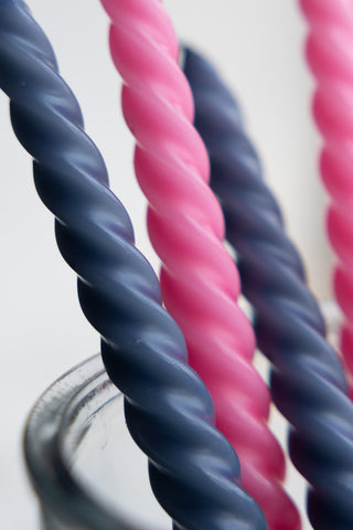 Close-up of the Set of 4 Twisted Dinner Candles in Pink & Dark Grey.