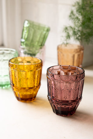 The Set of 6 Colourful Vintage-Style Glass Tumblers styled by a kitchen window with a plant.