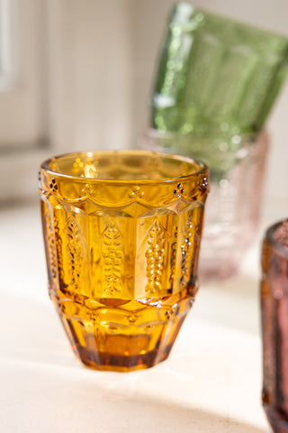 Close-up of one of the Set of 6 Colourful Vintage-Style Glass Tumblers, styled with others around it.