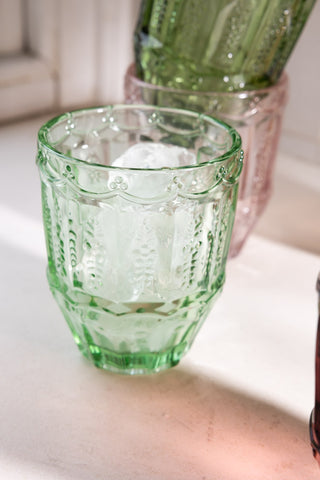 Close-up of one of the Set of 6 Colourful Vintage-Style Glass Tumblers with ice inside.