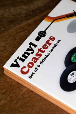 Detail shot of the box of the Set of 6 Vinyl Style Coasters on a wooden surface.