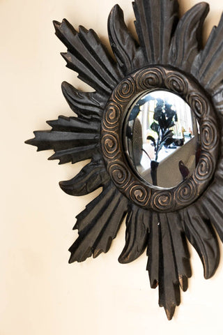 Detail shot of one of the Set of 9 Ornate Antique Black Framed Mirrors on a neutral wall.