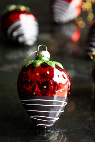 red strawberry christmas decoration with a dipped in chocolate effect.