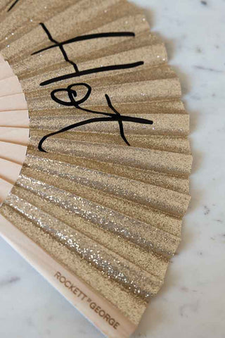 Close-up shot of the Shit Hot Black & Gold Glitter Fan.