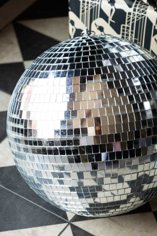 Close-up of the Silver Disco Ball - 30cm, styled on the floor.