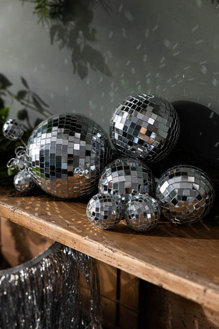 Close-up image of the Silver Disco Ball Cluster Christmas Decoration on a wooden surface.