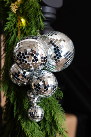 The Silver Disco Ball Cluster Decoration styled on a stair garland