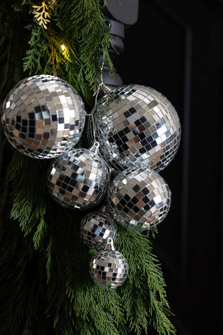 The Silver Disco Ball Cluster Decoration styled on a stair garland showing the connecting wire