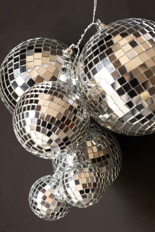 Close-up of the Silver Disco Ball Cluster Decoration displayed on a dark wall.