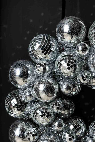 Close-up of the Silver Disco Ball Wreath displayed on a black door.