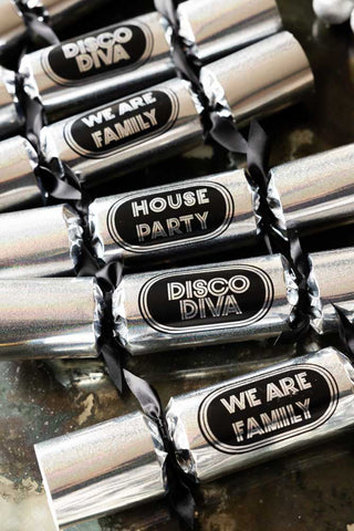 The six silver disco crackers with a metallic shimmer front and the phrases.