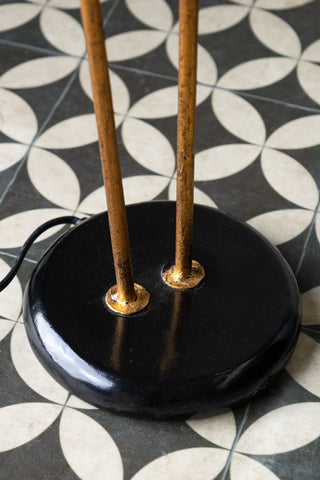 Close-up of the base of the Sleek Black & Gold Double Shade Floor Lamp.