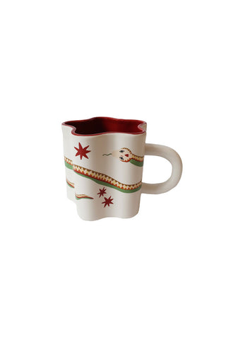 Cutout of the Star Shaped Mug with Snake Print Detail on a white background.