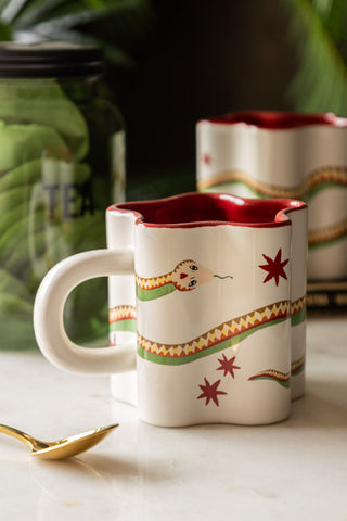 Star Shaped Mug with Snake Print Detail on white marble with gold spoon and tin of tea