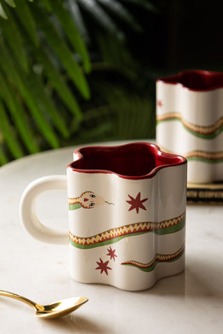 Star Shaped Mug with Snake Print Detail on white marble with plant 