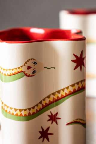 Close-up shot of the illustrative design on the Star Shaped Mug with Snake Print Detail.