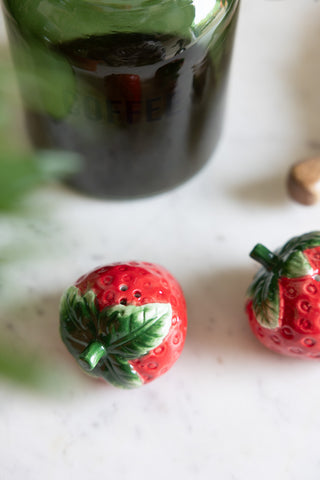 Close-up of the Strawberry Salt & Pepper Shakers styled on a marble surface.