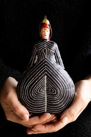 The Stripe Bowie Inspired Christmas Tree Decoration being held in a model's hands.