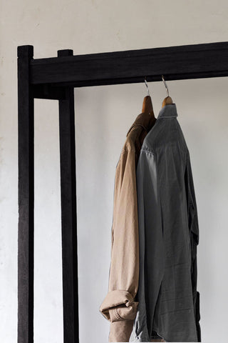 Close-up of the Stylish Mango Wood Freestanding Open Wardrobe with some clothes hanging on.