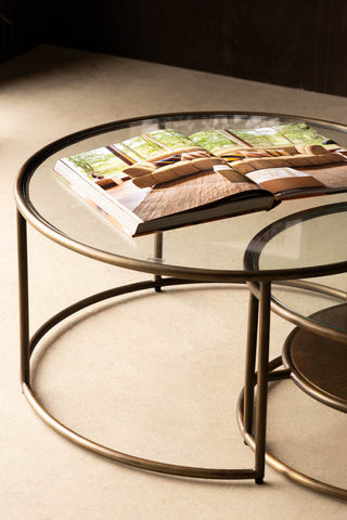 Sunrise Nest Of 2 Tables in a living room setting against a brown wall detail