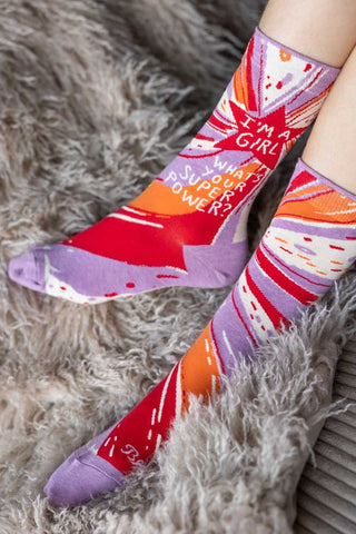 The Superpower Womens Socks being worn by a model, on a grey fluffy rug.