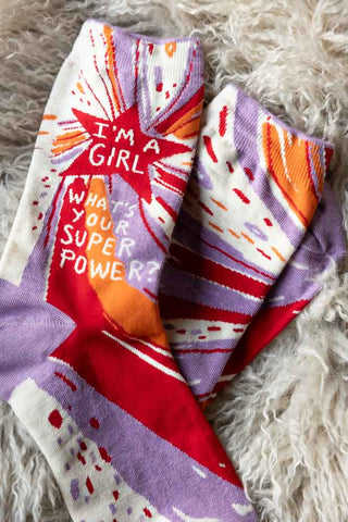 Close-up of the Superpower Womens Socks displayed on a fluffy rug.