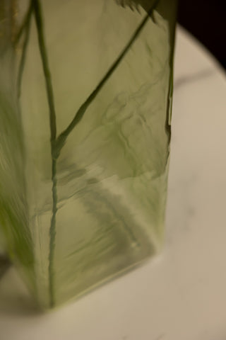 Close-up of the surface of the Tall Textured Glass Green Vase.