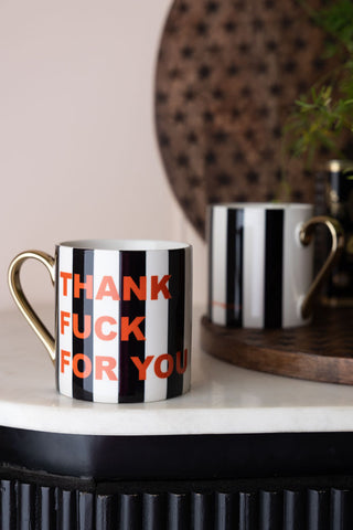 Two of the Thank Fuck For You Stripe Mugs styled with wooden serving boards.