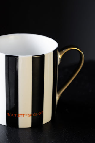 Close-up of the reverse side of the Thank Fuck For You Stripe Mug, showing the Rockett St George logo.