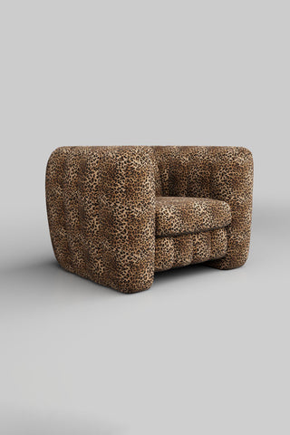 The Bowie Love Seat In Leopard Love Velvet Natural on a pain background, seen from a side angle.